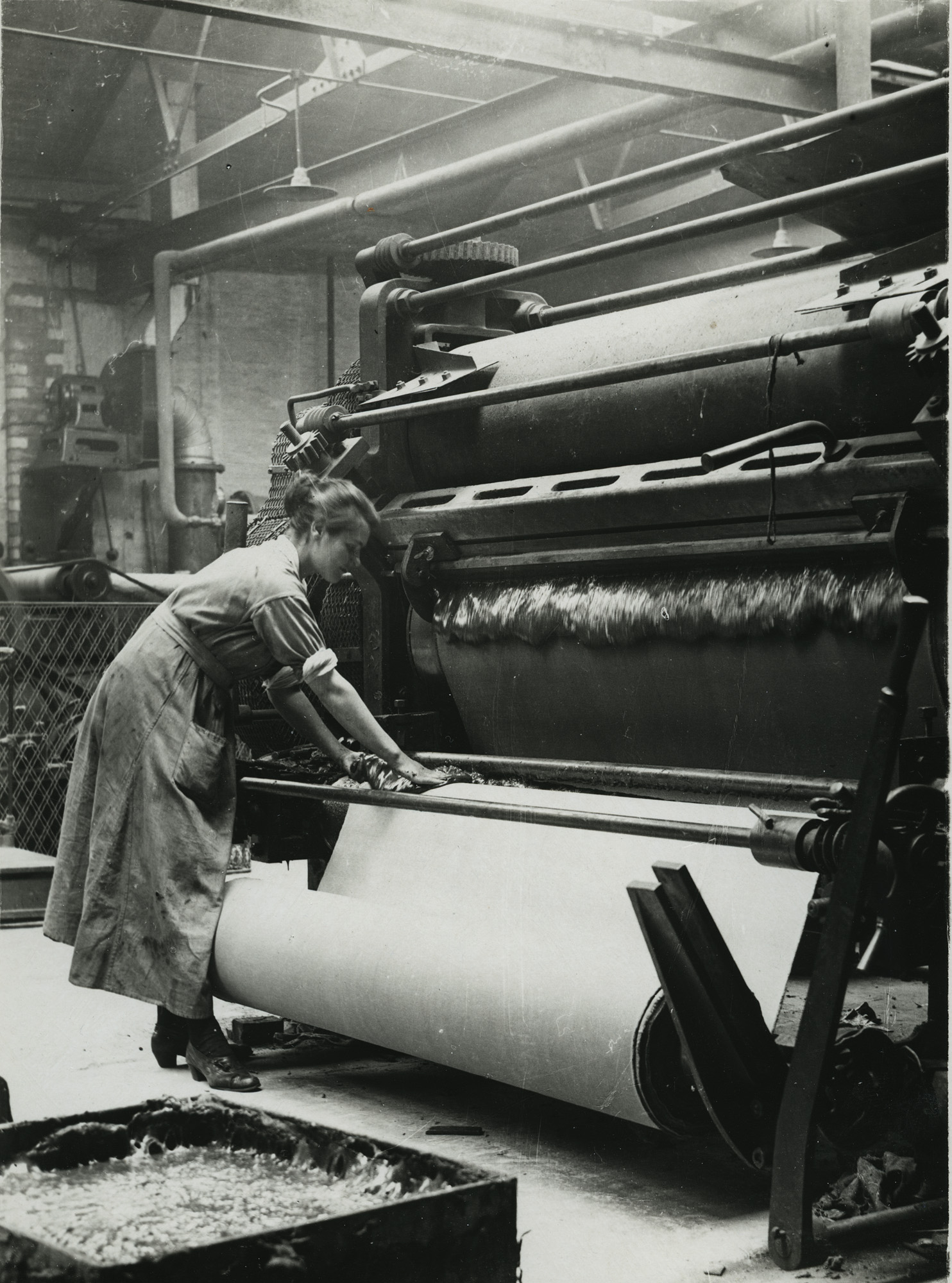 British rubber workers in Lancashire spreading machine for coaling canvas for tire making (15082442209)