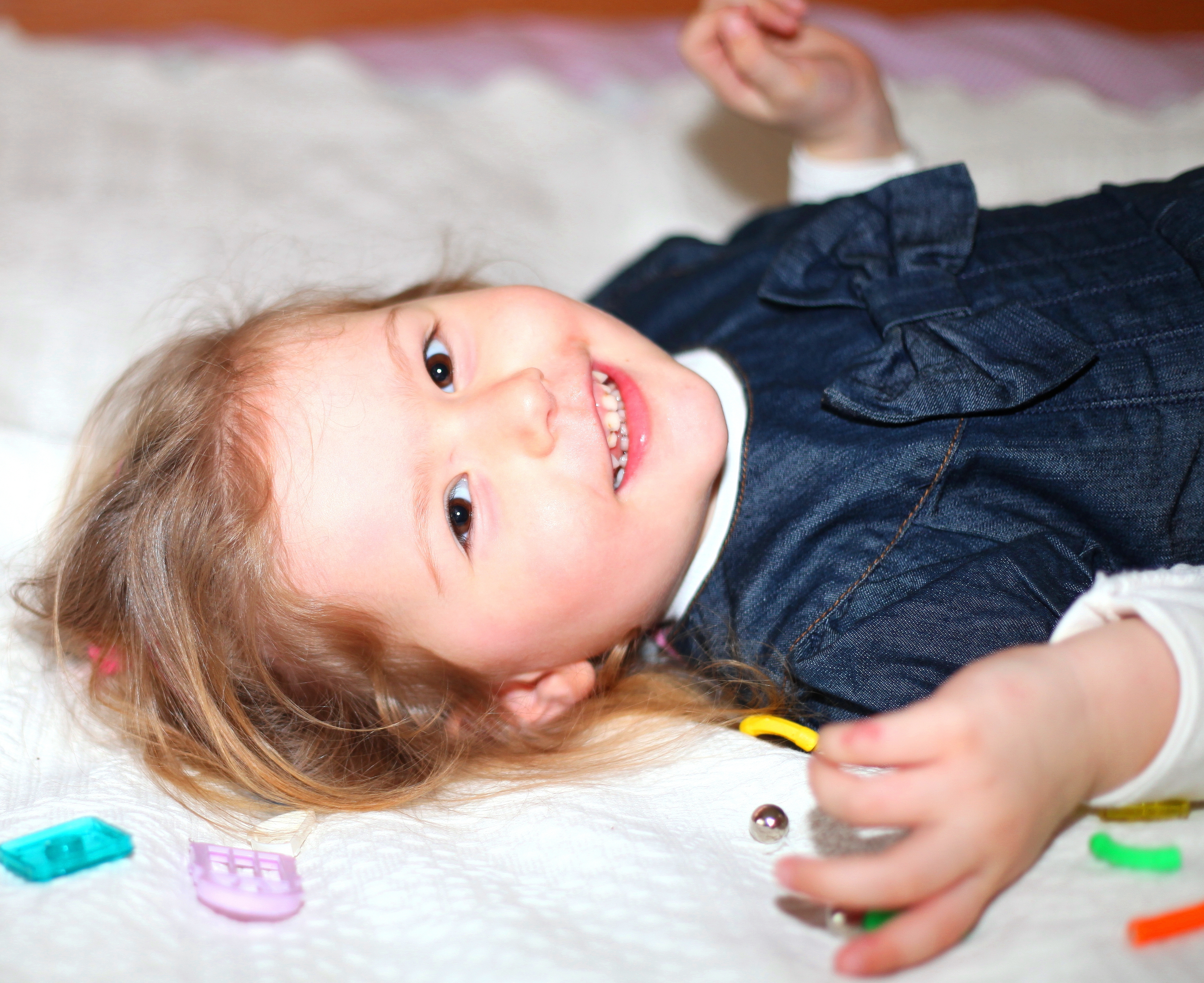 a cute Catholic child girl lying on a bed