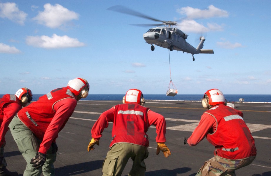 US Navy 021002-N-4953E-007 Aviation Ordnancemen from the Truman and Carrier Air Wing Three (CVW-3) prepare to move ammunition