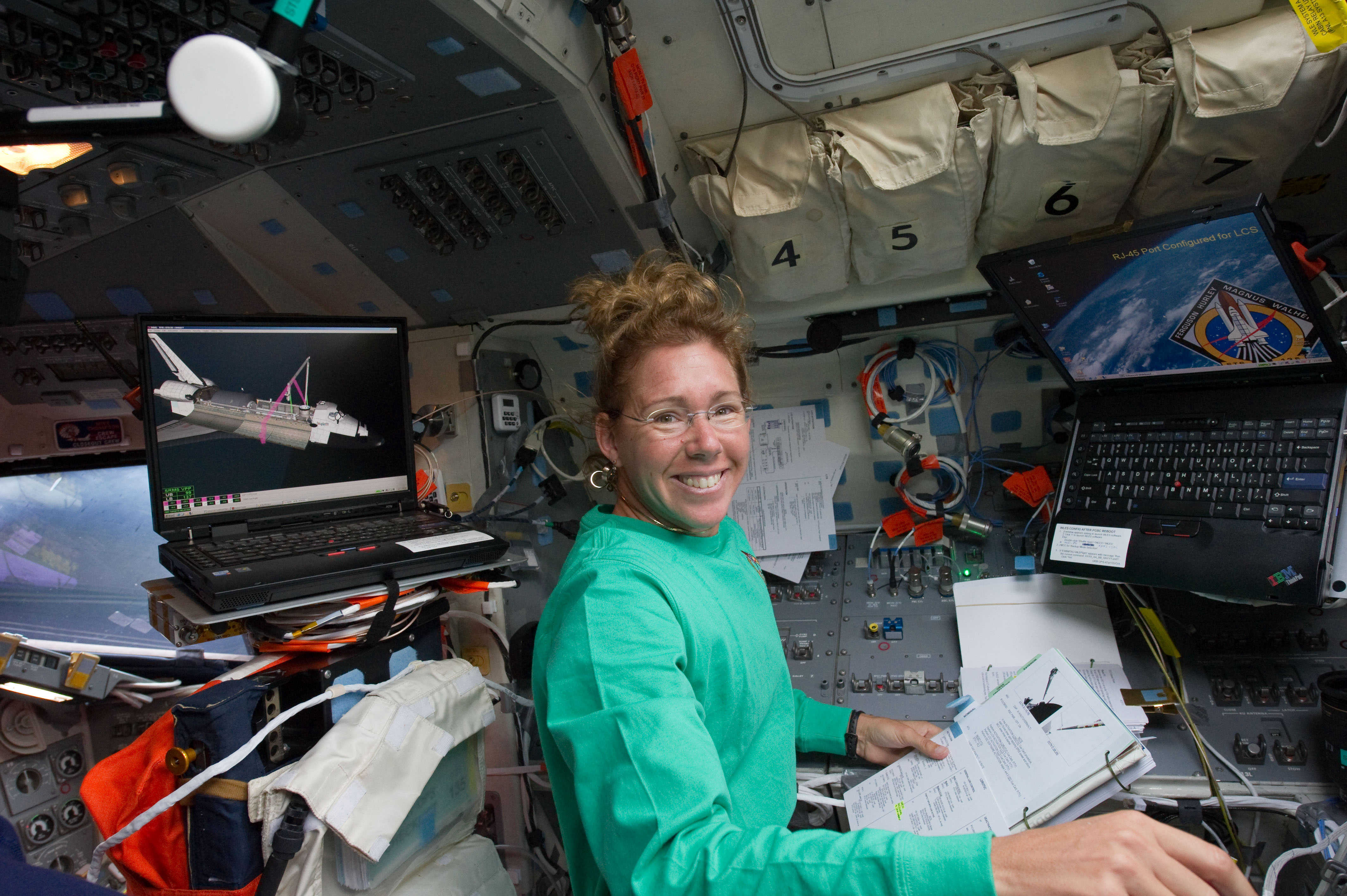 STS-135 Sandy Magnus on the flight deck