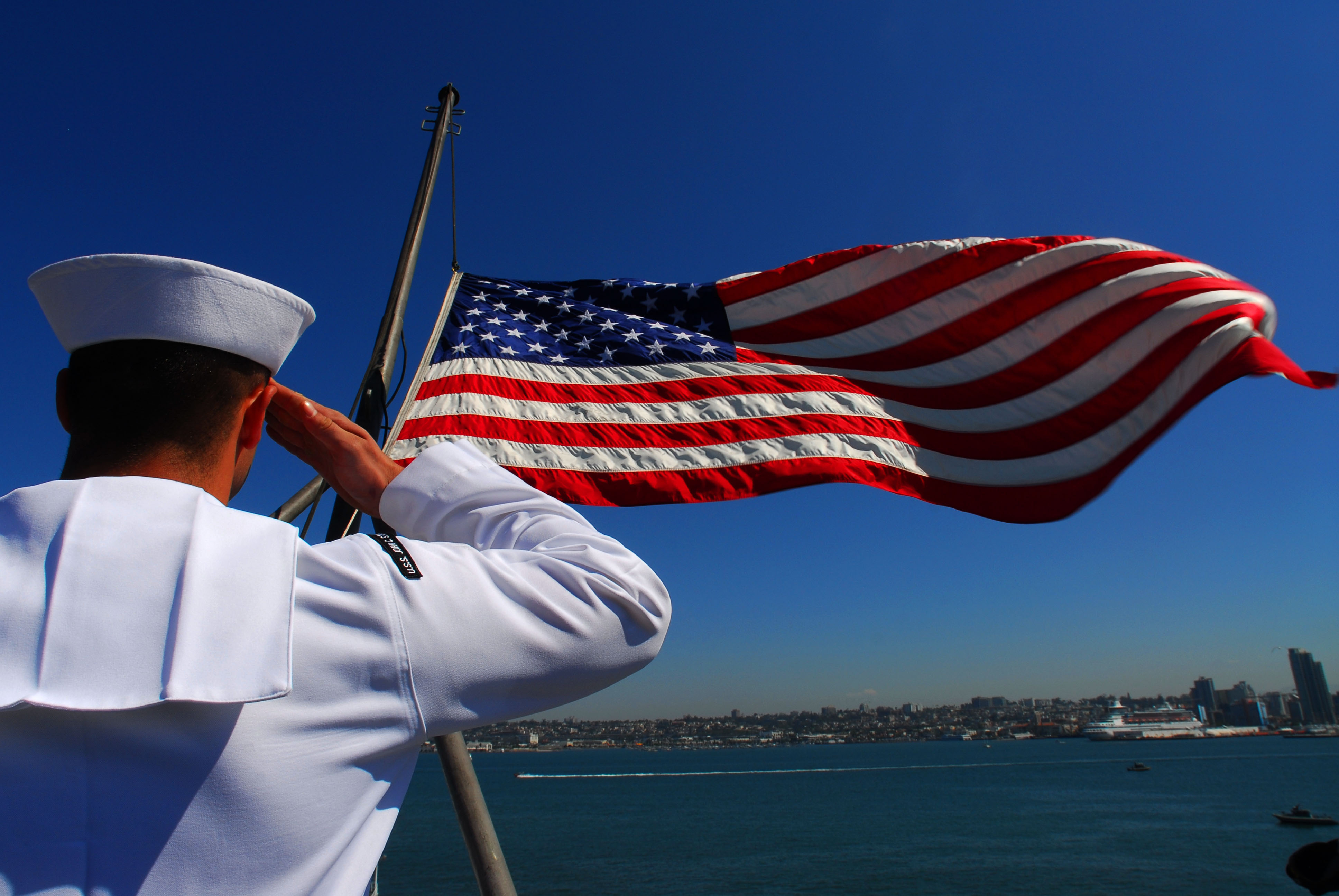 US Navy 070828-N-2659P-007 Aviation Boatswain's Mate (Fuel) Airman Apprentice Moses Perez salutes the national ensign as it is lowered signaling that the Nimitz-class aircraft carrier USS John C. Stennis (CVN 74) is underway