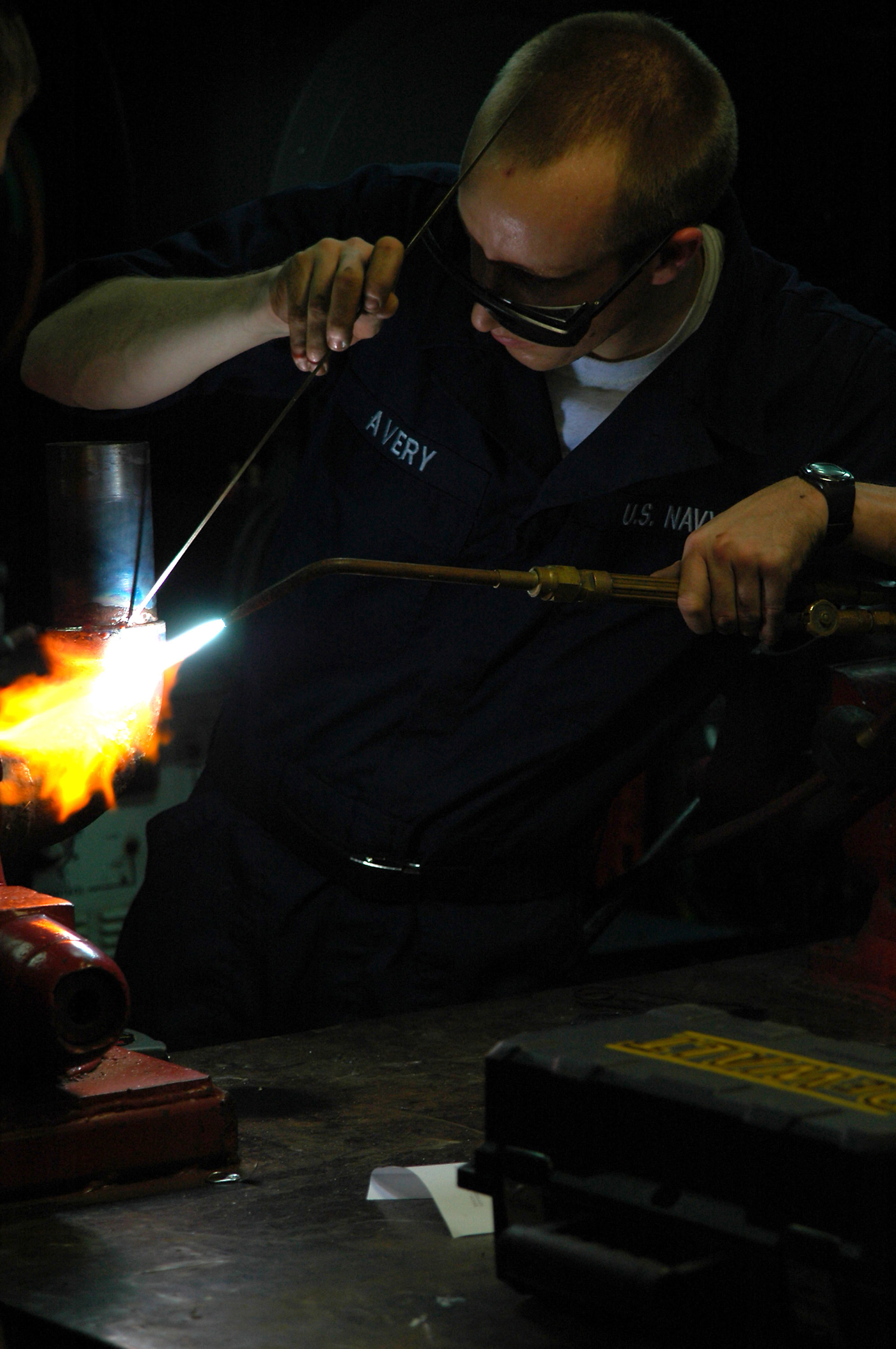 US Navy 080214-N-2832L-054 Hull Maintenance Technician Fireman Nathan Avery braze welds a drainage eductor aboard amphibious assault ship USS Tarawa (LHA-1)