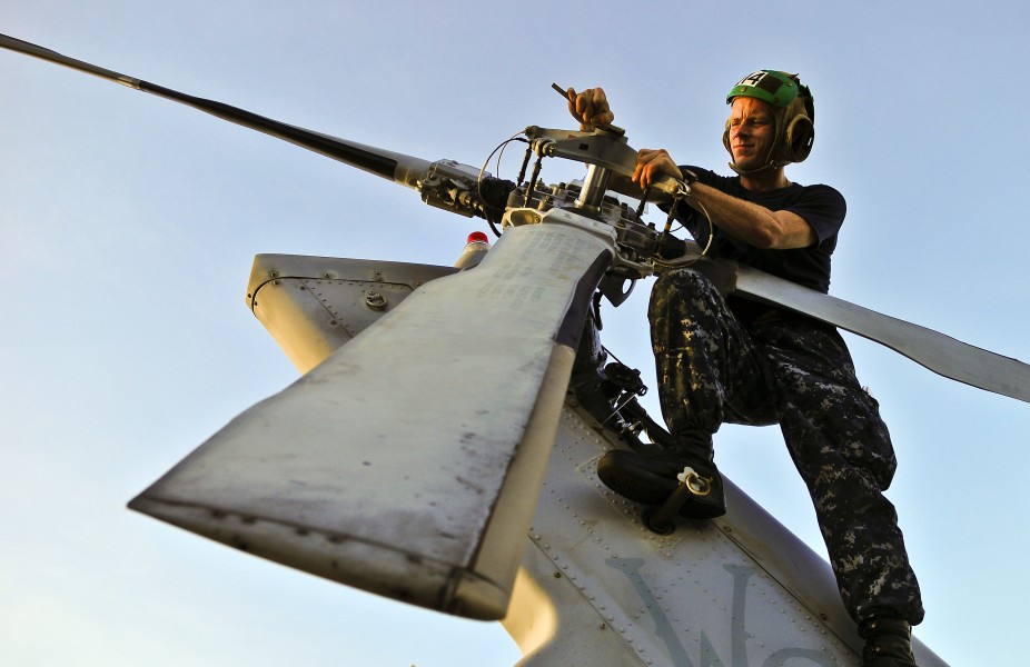 US Navy 110523-N-KB563-134 Aviation Electronics Technician 3rd Class Joe Jenkins checks for corrosion on the tail rotor of an MH-60S Sea Hawk helic