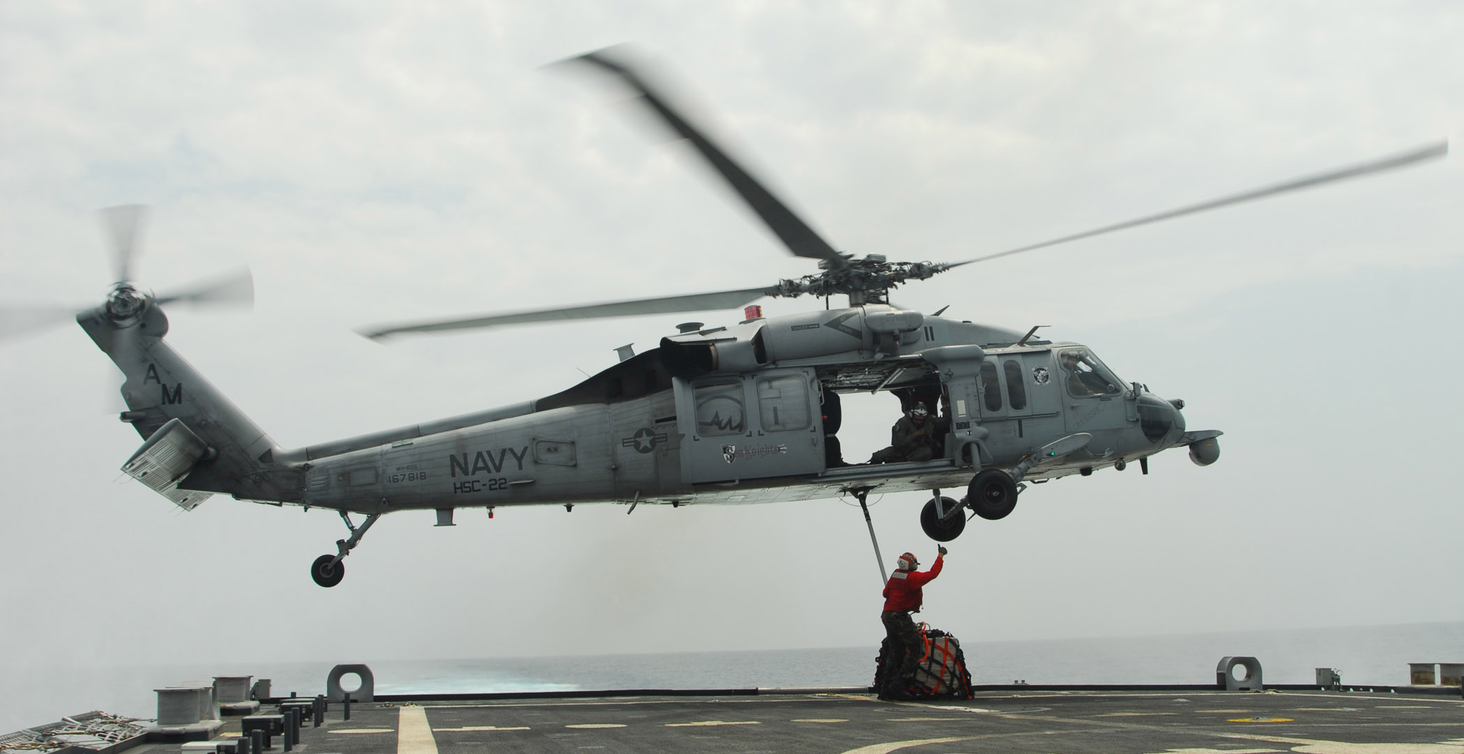 US Navy 100303-N-7058E-469 Aviation Ordnanceman 2nd Class Richard Goodley, assigned to the littoral combat ship USS Freedom (LCS 1) gives a thumbs-up to the pilot of an MH-60S Sea Hawk helicopter